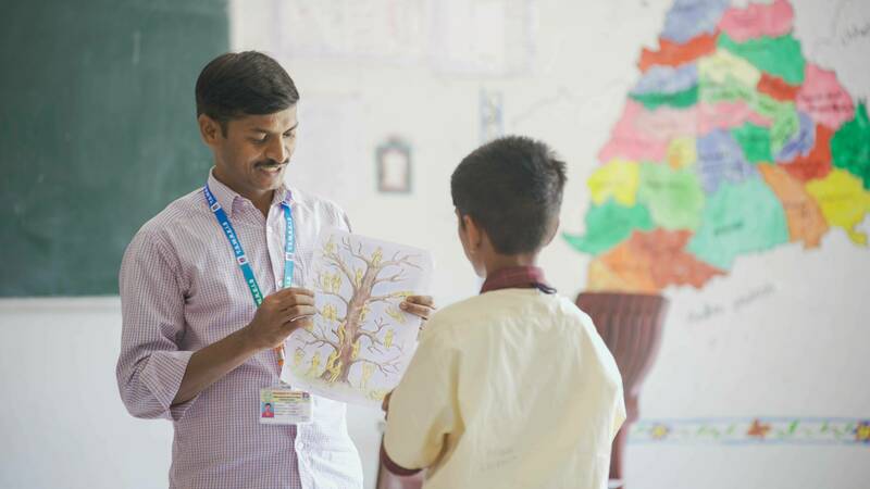 A boy and a teacher participate in a Global Center for the Development of the Whole Child program in India