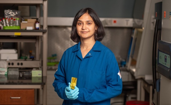 Postdoctoral fellow Himani Sharma holds a prototype of the device in the Chang Lab.