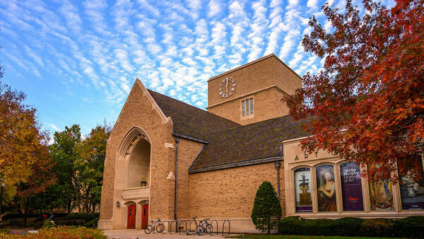 O'Shaughnessey building in the fall with a blue sky and clouds