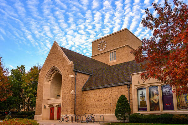 O'Shaughnessey building in the fall with a blue sky and clouds