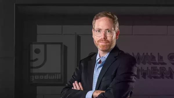 Patrick Turner standing in front of a Goodwill storefront