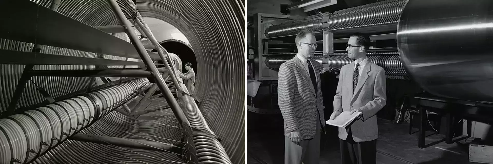 A scientist inspects intricate coils inside a large, corrugated cylinder. Two men in suits discuss documents near similar industrial equipment in a lab.